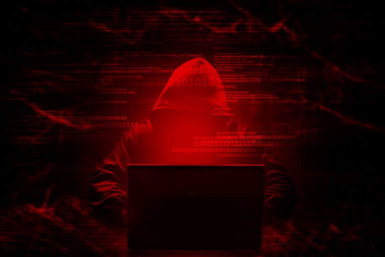 Internet crime concept. Hacker working on a code on dark digital background with digital interface around