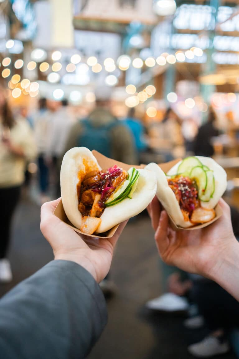 Personal perspective shot of a couple eating street food at a festival