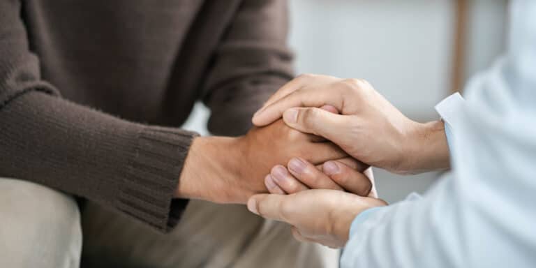 Male doctors shake hands with patients encouraging each other and praying for blessings. To offer love, concern, and encouragement while checking the patient's health