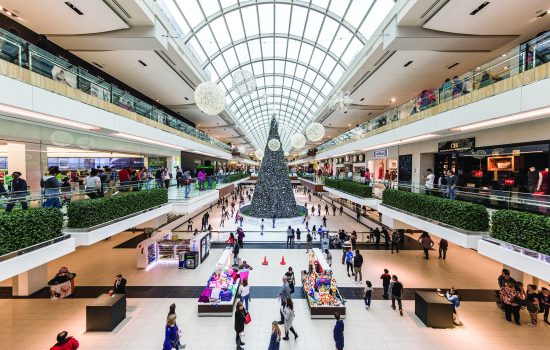 Houston, Texas - December 23, 2016: People Busy Christmas Holiday Shopping in the Galleria Shopping Mall, Giant Christmas Tree and Skate Rink are visible in the distance